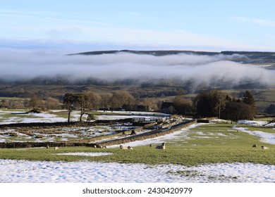 Mist rising over a winter countryside landscape in morning sunshine