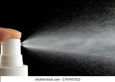 Mist Spray Aerosol Bottle For Perfume Isolated On Black. Splash Water Liquid Background.