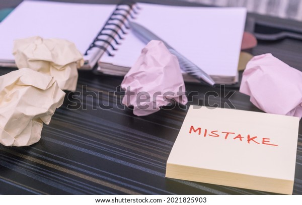 Mistake written on sticky notes. Learning,\
wrong, blooper, error message, regret sayings background. Fault,\
defect, careless, lesson correction and reconciliation concept for\
business finance\
industry