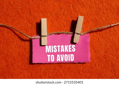 Mistakes to avoid message written on ripped torn paper background. Conceptual Mistakes to avoid symbol. Copy space.