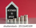 MISTAKES TO AVOID symbol. Concept words MISTAKES TO AVOID written on a black board. Silver coins arranged in a graph in front. Beautiful red background, grey table. Business concept. Copy space.