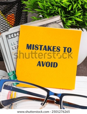 MISTAKES TO AVOID, text on a yellow sticker on the table