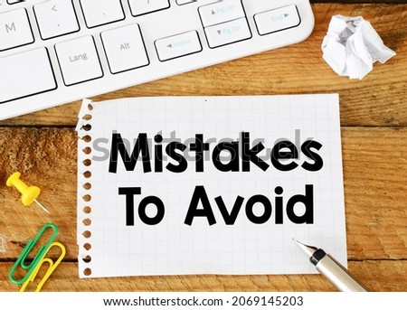 MISTAKES IS AVOID words written in the notebook.