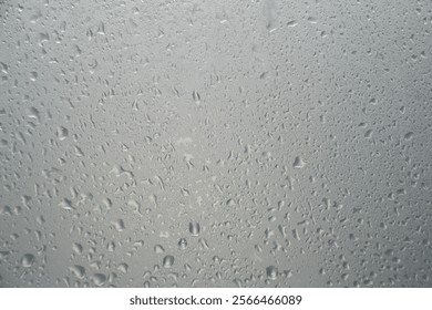 Misted glass background and Detail of water droplets, gloomy gray day. Window and rain outside | Foreground overlay for beauty and skin care products - Powered by Shutterstock