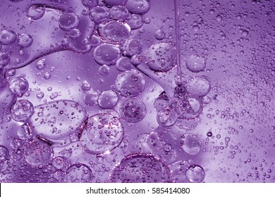 Misted glass, purple rain drops dew drops on colorful abstract cool color background condensation on tinted vibrant glass window