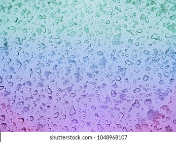 Misted glass  vibrant rainbow tinted glass and mixed rain   snow droplets  beautiful natural water droplets fall pastel rainbow background