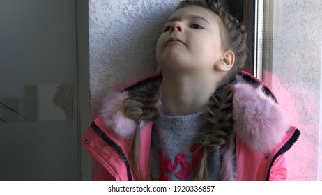 Mistreated Child. Sad Little Girl By The Window.