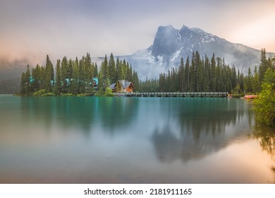 A misty, atmospheric sunrise or sunset over traditional log cabin and beautiful Rocky Mountain landscape at Emerald Lake, B.C., Canada near Field British Columbia, in Yoho National Park. - Powered by Shutterstock