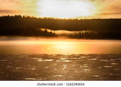 Misty Calm Evening On The Forest Lake Is Illuminated By The Colors Of Sunset, Melting Ice, Reflection In The Water Mirror. Spring In The Arctic North. Scandinavia, Lapland