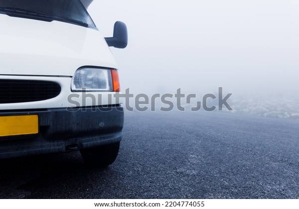 Misty and dangerous looking road. Foggy road in\
the woods. Caution\
highway