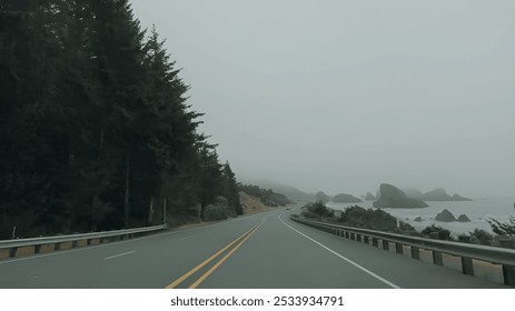 A misty drive along the scenic Oregon Coast, with a winding road bordered by dense forests on one side and the rugged shoreline on the other. - Powered by Shutterstock