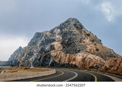 Misty evening at Mohamadia Mountain, Taif, with a winding road disappearing into the fog, highlighting the serene and mysterious beauty of the landscape. Taif Saudi Arabia. Oct 25, 2024 - Powered by Shutterstock