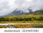 Misty fall landscape, the Brooks River and mountain above, Katmai National Park, Alaska

