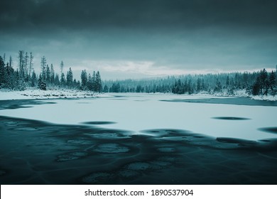 Misty and foggy morning at a peaceful forzen mountain lake with dramatic light and contrast of the frozen nature. Wonderful and beautiful nature scene. Oderteich, Harz Mountains National Park, Germany