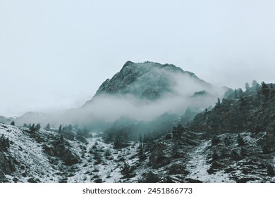 Misty foggy mountain landscape. Snowy peak - Powered by Shutterstock