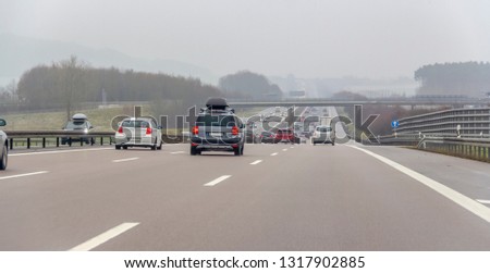 misty highway scenery at winter time in Southern Germany