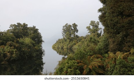 Misty Lake Surrounded by Foliage - Powered by Shutterstock