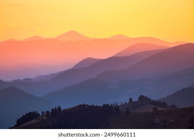 Misty layers of mountains and silhouettes ridgelines going into the distance under the evening sunlight. Location place Carpathian National Park, Ukraine, Europe. Photo wallpaper. Beauty of earth. - Powered by Shutterstock