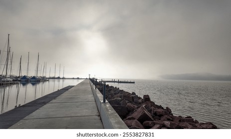 A misty marina with sailboats docked, symbolizing tranquility and introspection, perfect for promoting peaceful holiday retreats - Powered by Shutterstock