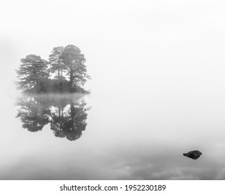 Misty mono Autumnal reflections in the Lake District.