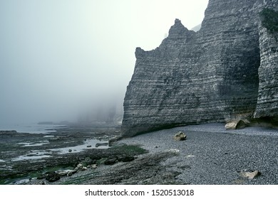 Misty Morning Fog At The Rocky Beach In Normandy.