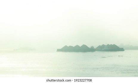 Misty Morning In Mahakam River, Tugboat Dragging Barge Full Of Coal, Samarinda, Indonesia.