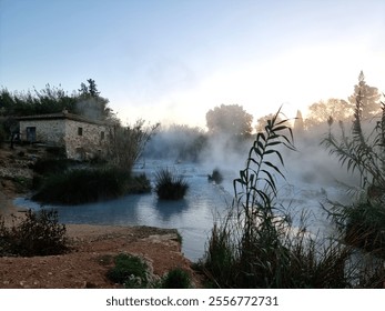 Misty morning on Cascade mulino di Saturnia, famous natural hot springs in Tuscany, Italy	 - Powered by Shutterstock