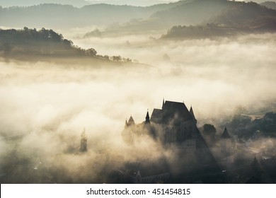 Misty morning over Biertan village, Transylvania, Romania - Powered by Shutterstock