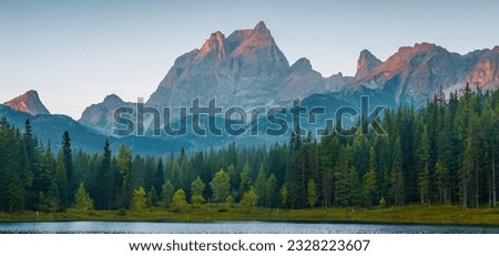 Misty morning scene of  forest lake in highland with rocky peak. High resolution.