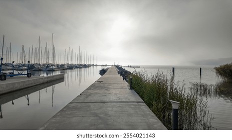 Misty morning at a tranquil marina with sailboats, perfect for concepts of solitude, reflection, and early morning calm - Powered by Shutterstock