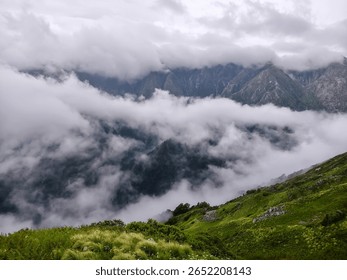 Misty Mountain Landscape with Dramatic Cloud Cover and Lush Valley View