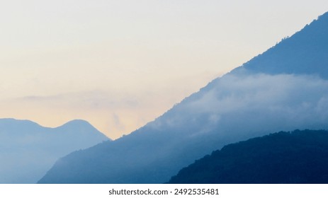 
Misty Mountain Layers at Dawn: A tranquil dawn scene with mist rolling over layered mountain peaks, creating a peaceful and ethereal atmosphere. Ideal for projects focused on nature and serenity. - Powered by Shutterstock