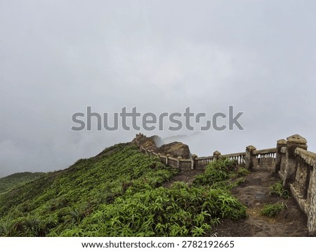 Misty Mountain Path with Stone Railing at Mount Kabah Summit