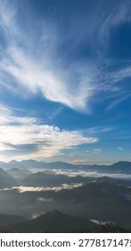 Misty Mountain Range Under Cloudy Sky