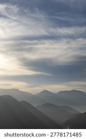 Misty Mountain Range Under Cloudy Sky