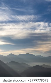 Misty Mountain Range Under Cloudy Sky