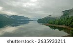 A misty start to the day in summer over Loch Long from Arrochar, Argyll, Scotland, UK