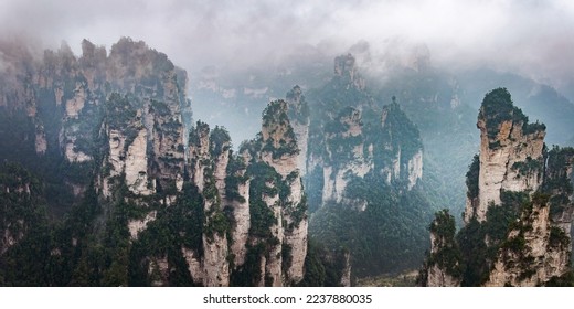 Misty steep mountain peaks in Zhangjiajie, China. Avatar floating mountains panorama.