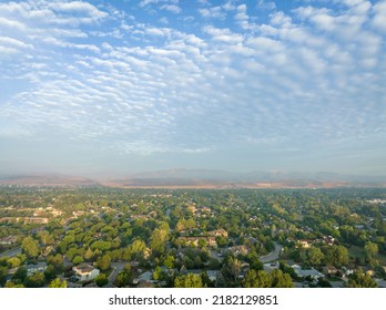 misty summer morning over Fort Collins and foothills of Rocky Mountains in northern Colorado, aerial view after heavy rainstorm with altocumulus clouds
