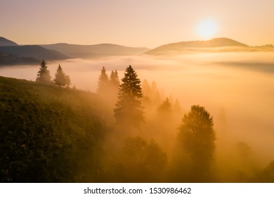 Misty sunrise in the mountains with a beautiful sky. Aerial view - Shutterstock ID 1530986462