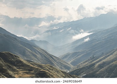 Misty terraced mountains in Vietnam with soft clouds floating above - Powered by Shutterstock