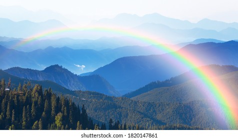 Misty view of the blue mountain range with amazing rainbow -  Beautiful landscape with cascade blue mountains at the morning