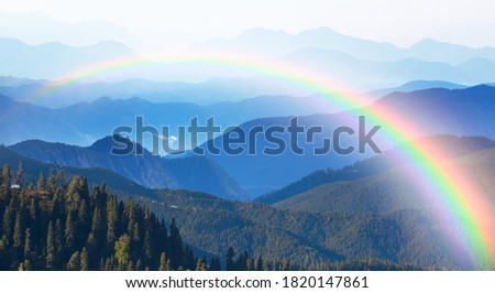 Misty view of the blue mountain range with amazing rainbow -  Beautiful landscape with cascade blue mountains at the morning