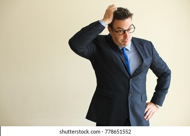 Misunderstanding Businessman Clutching Head