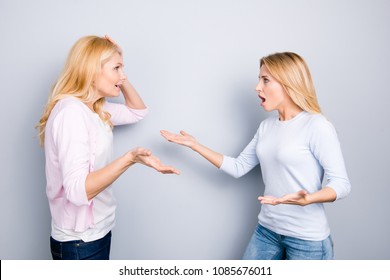 Misunderstanding disagreement insult concept, nervous irritated unhappy disappointed upset mother and daughter yelling at each other arguing having dispute quarrel isolated on grey background