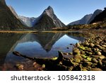 Mitre Peak mountain reflection on water in Fiordland National Park in the South Island of New Zealand, located on the shore of Milford Sound. No people. Copy space