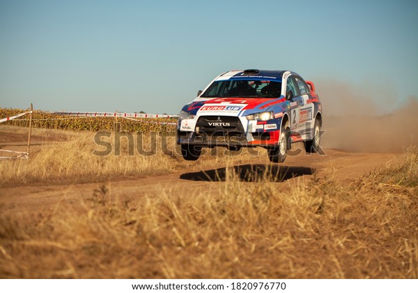 Mitsubishi Lancer Evolution jumping in motion\
with clouds of dust during the Ukrainian Championship in mini-rally\
\
