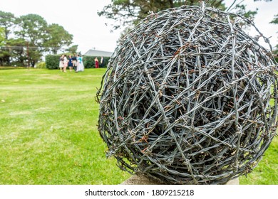 Mittagong, Australia – Mar 23, 2019: Barb Wire Rolled Up Into A Ball Shaped Ornament, Anchored Onto A Fence In A Public Park.