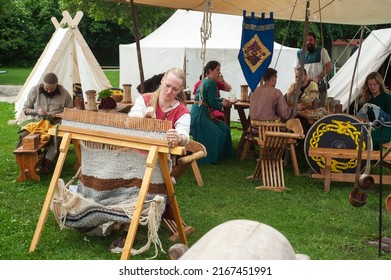 Mittelaltermarkt 2022, Medieval Market festival in Ulm, Germany - 27 May 2022. Artisan makes fabric. Market offers medieval entertainment and workshops and classes.