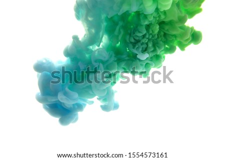 Mix of abstract blue and green ink in water on a white background. It looks like smoke or cloud. Or zero gravity.